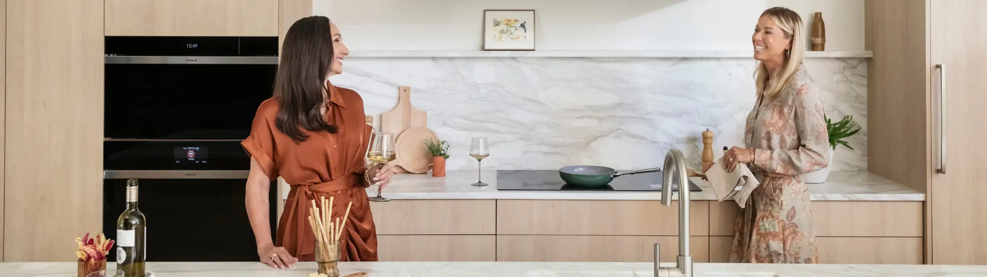 two high-class ladies enjoying Wolf's appliances
