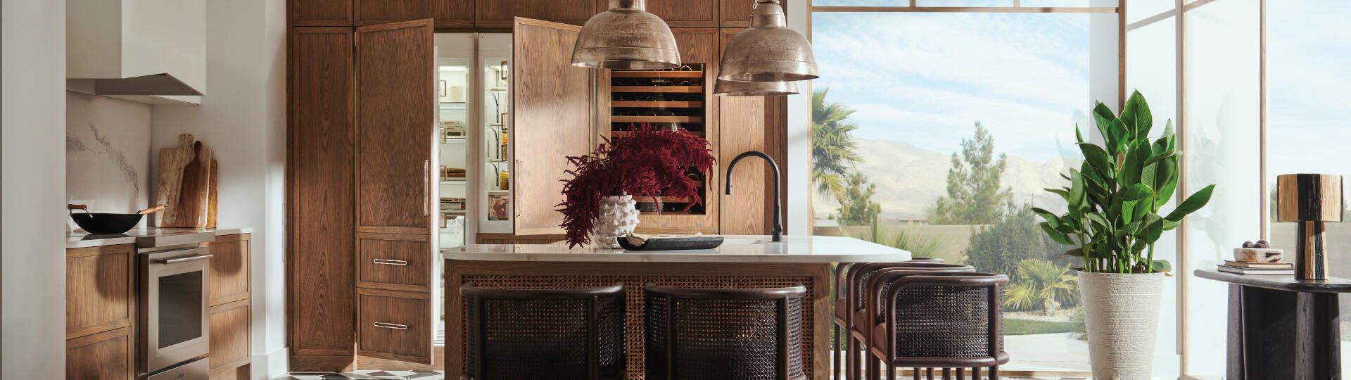 Designer refrigerator, wine storage and ovens all blended in wood wall panels