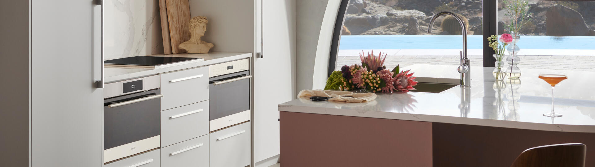 Wolf ovens and Sub-Zero's designer refrigeration in a modern household with a pool